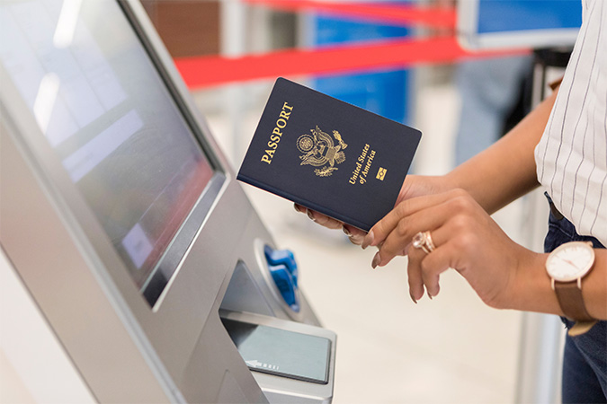 A woman holding up her passport.